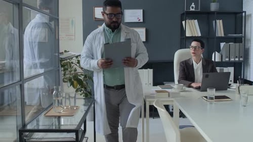 Healthcare Professionals Gathering in Medical Office for Team Meeting