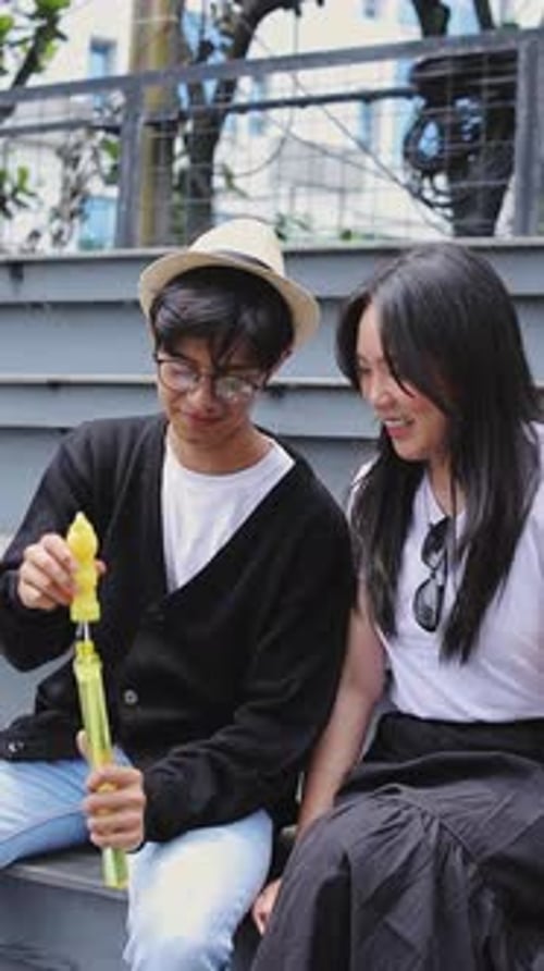 Asian Couple Blowing Bubble Soap Together