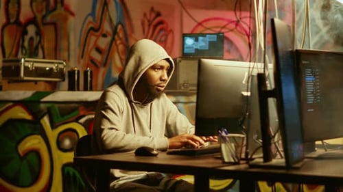 Young Adult Typing at Computer in Urban Setting