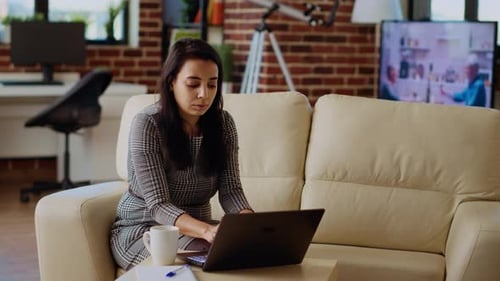Woman Works on Laptop in Modern Apartment