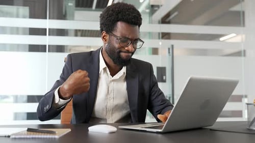 Man Massaging Wrist While Using Laptop