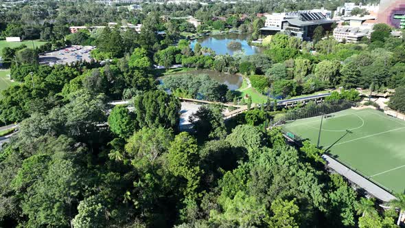 Drone shot of University of Queensland UQ St Lucia, panning up above UQ ...