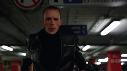 Portrait of Exhausted Criminal Man Running Away From Policeman in Urban Building