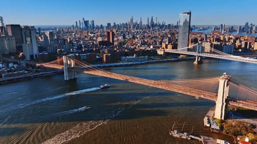 The East River with the Manhattan Bridge and Brooklyn Bridge at sunset.
