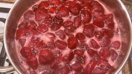 Cooking Strawberries in Pot for Jam Preparation