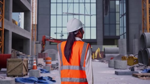 Asian Female Walking at Construction Site