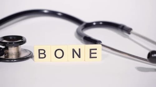 Stethoscope and "Bone" Spelling near Medical Equipment