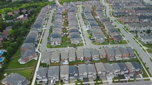 Aerial view of suburban neighborhood, flying left and slowly panning