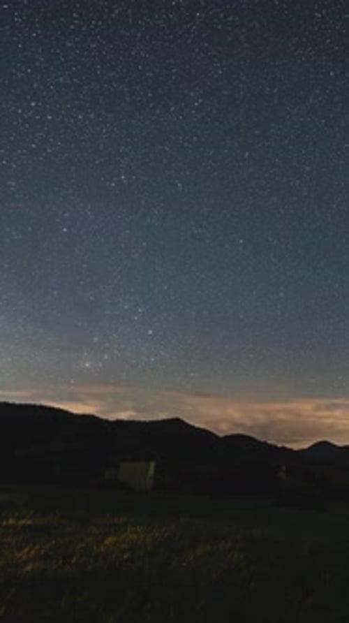 Time Lapse Starry Night Sky over Mountains
