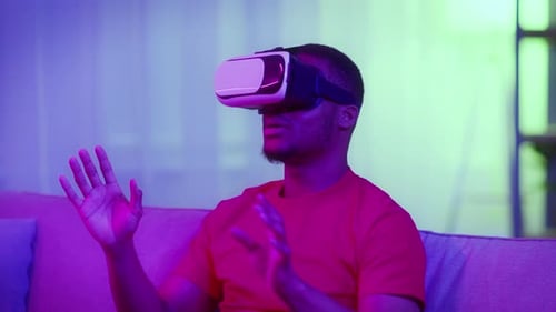 Young Adult Immersed in Virtual Reality at Home