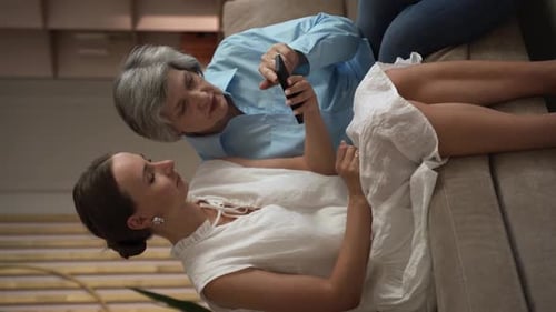 Woman and Senior Woman Using a Smartphone
