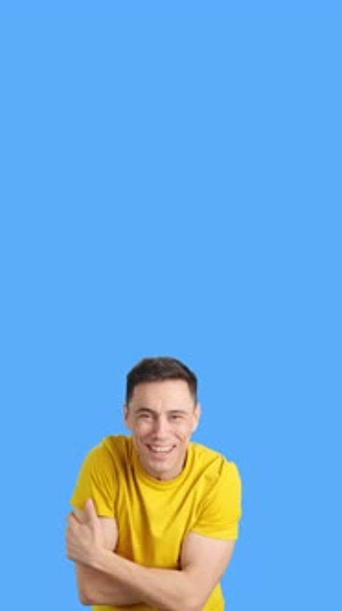 Enthusiastic Young Adult Gesturing with Yellow Shirt