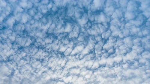 Cloud Formations in Time Lapse Effects. Cotton Cloud Cluster on Blue Sky Background. Beautiful Cloud