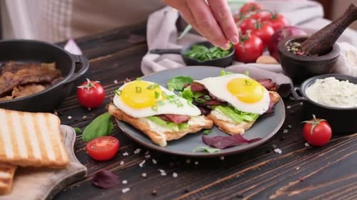 Fried Egg Toast with Bacon Being Seasoned
