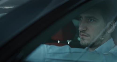 Man Drives Car at Night, Close Up