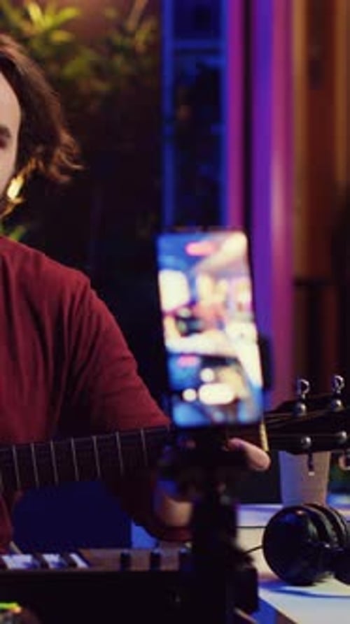 Young Adult Recording a Guitar Tutorial