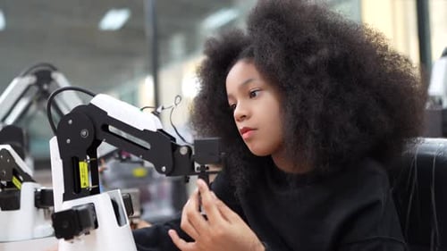 Diverse schoolkids working on robotic technologies at STEM educational class.