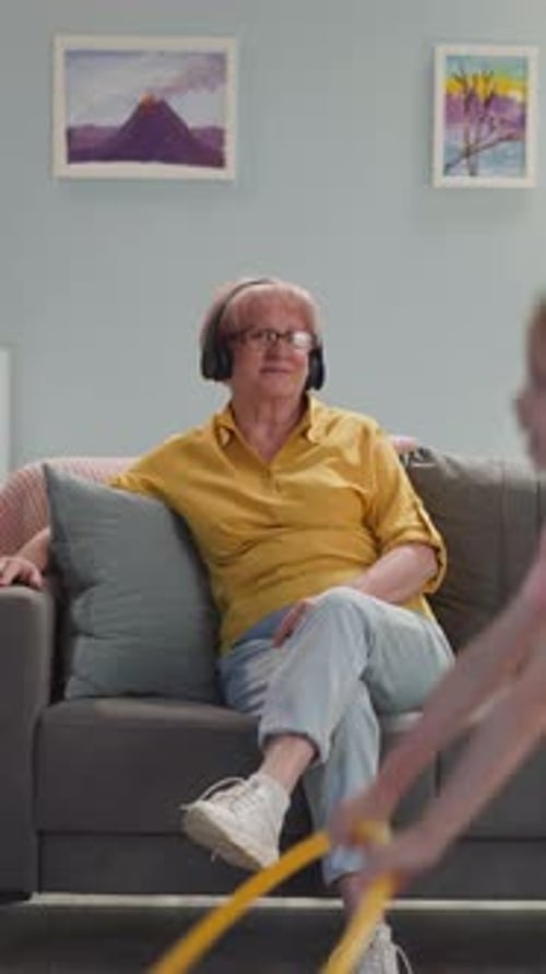 Grandmother Relaxing as Granddaughter Plays with Hoop