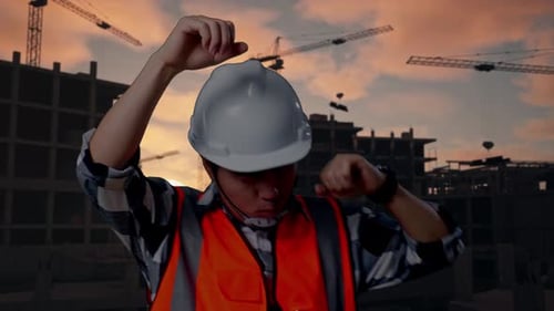 Close Up Of Asian Male Engineer Screaming Goal And Dancing Celebrating At Building Site