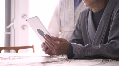Senior Couple Using Tablet at Table Together Indoors