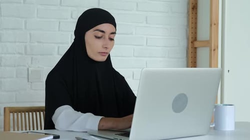 Muslim Woman College Teacher Typing on Laptop Keyboard