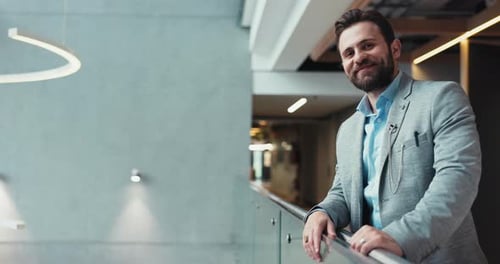 Happy, businessman or office building with balcony for corporate ambition or development