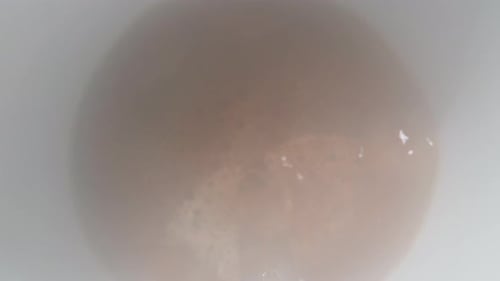 I pour instant coffee with hot water, a white mug, the camera fogs up. Dolly slider extreme close-up