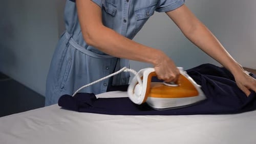 Unrecognizable Woman Ironing a Man's Shirt at Home Domestic Life Chore