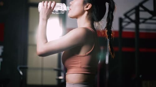Fit Woman Drinks Water After Gym Workout