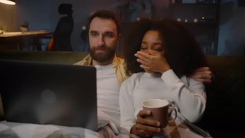 Cozy Couple Watching Laptop Together at Home