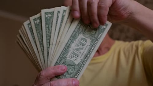 Senior Adult Fanning One Dollar Bills