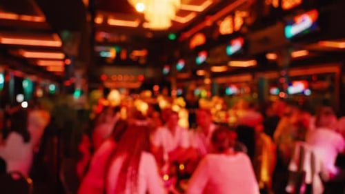 A Blurry Background Image of a Lively and Crowded Bar Featuring Warm Lighting and a Vibrant Social