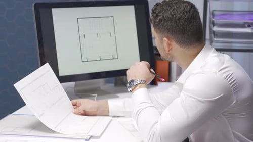 Male Architect are working on a model of a building or shop in the office.