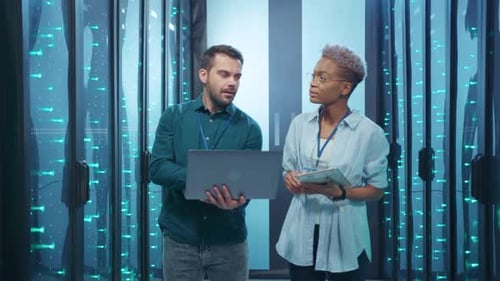 Experienced Data Analysts Working Together in a Modern HighTech Server Room Environment