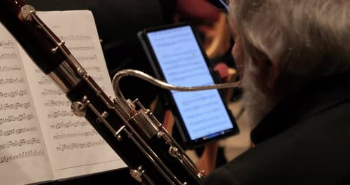 Close up shot of a talented musician playing a bassoon instrument during a classical music concert b
