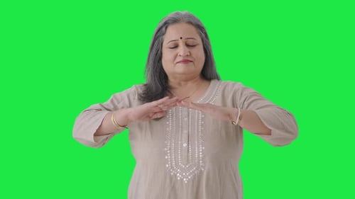 Happy Indian old woman doing breathe in breathe out exercise Green screen