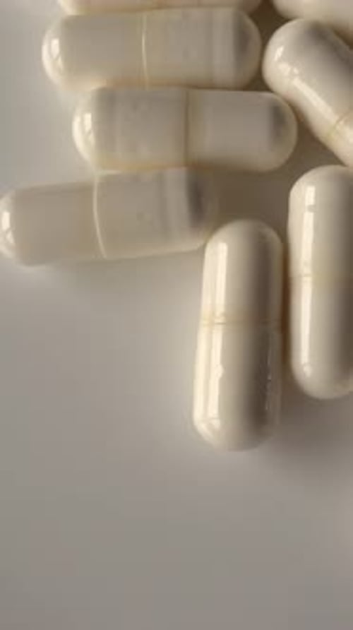 Vertical video of White Medical capsules