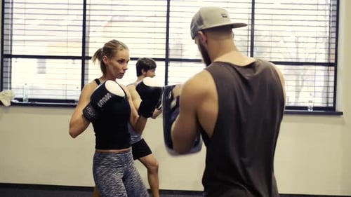 Woman in Gym Boxing with Her Personal Trainer