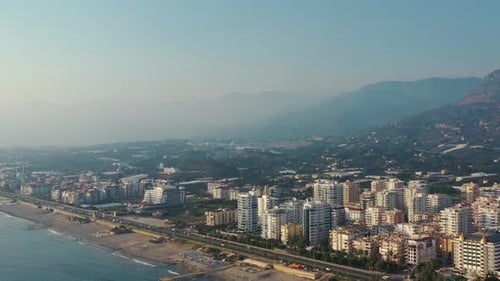 Aerial panoramic view of modern city with beach and traffic at daytime