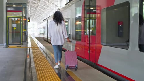 Girl Traveler with Luggage on Station Platform