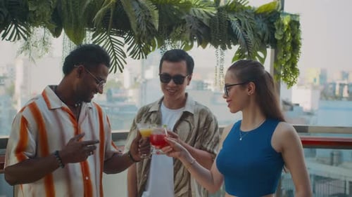 Friends Clinking Glasses when Celebrating with Cocktails in Cafe