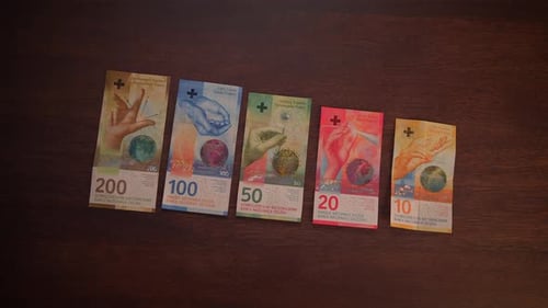 Swiss Franc Banknotes Arranged on Wooden Surface