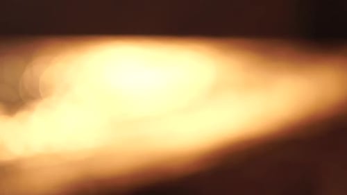 Blurred Golden Sea at Sunset with the Sun Reflecting and Sparkling on the Waves Illuminating the