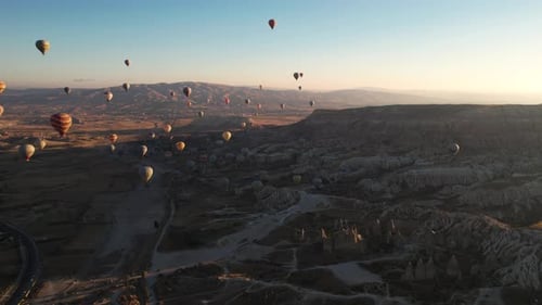 Drone Aerial View of Hot Air Balloons Above Goreme, Cappadocia, Turkey. Fairytale Scenery at Sunrise