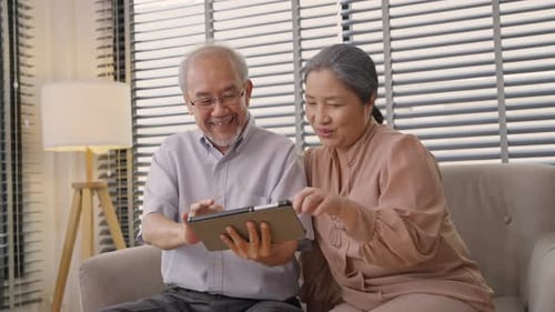 Elderly Couple Using Tablet Together at Home