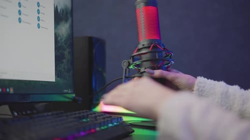 Freelancer Positioning Studio Microphone Near RGB Desktop for Podcast Recording