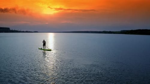 Paddleboarding at Sunset on Calm Waterway
