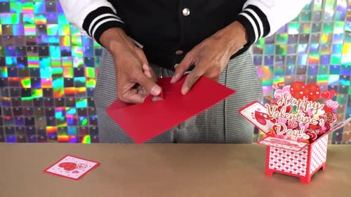 Hands Sealing Red Valentine's Day Envelope