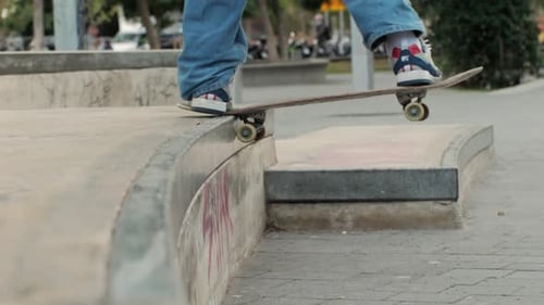 Young Skater Making Jump and Tail Slide on Box Performing Trick Skateboarder Training in Skatepark
