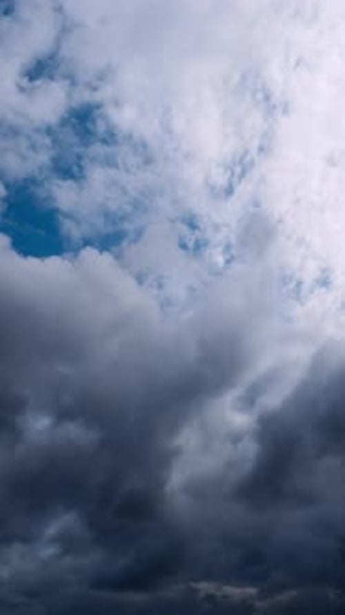 Vertical Dramatic Dark And White Clouds In Blue Sky
